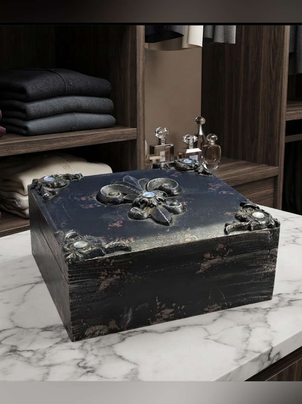 Black wooden box w/ ornate corner detailing and a central fleur-de-lis motif